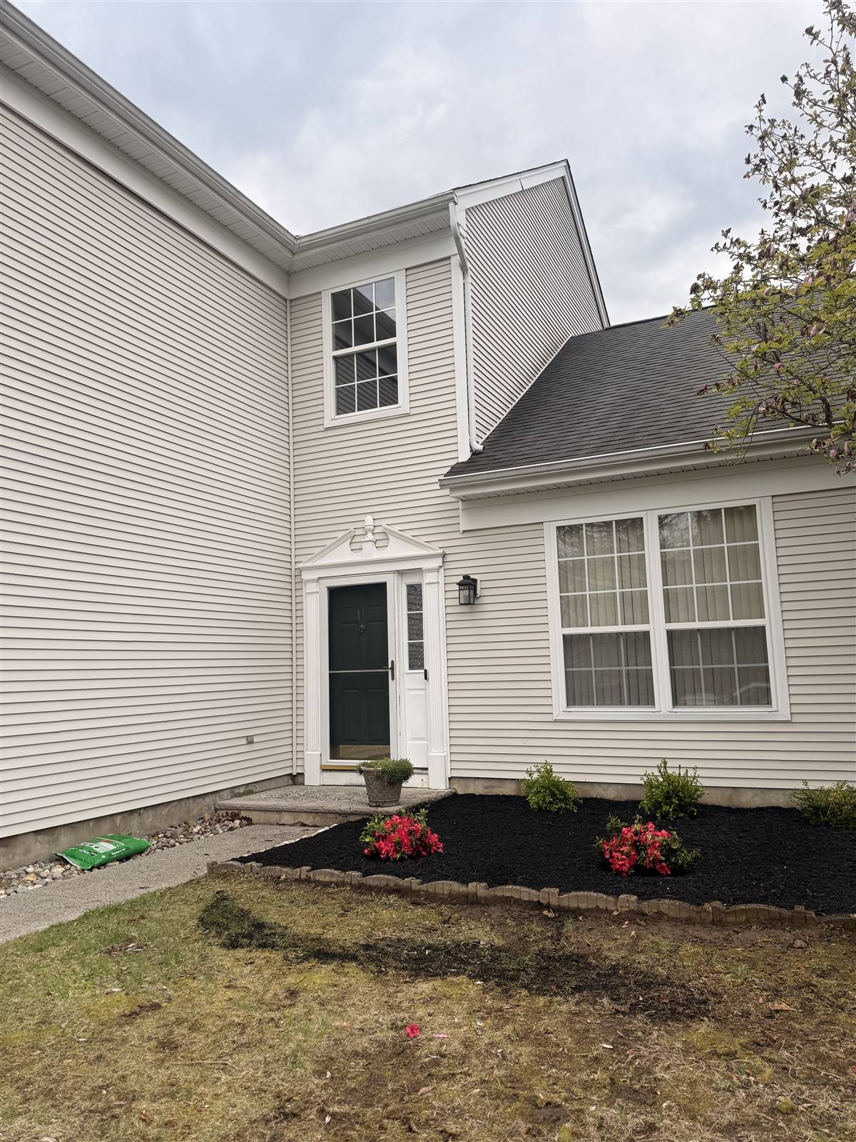 After — black mulch beds with red annuals