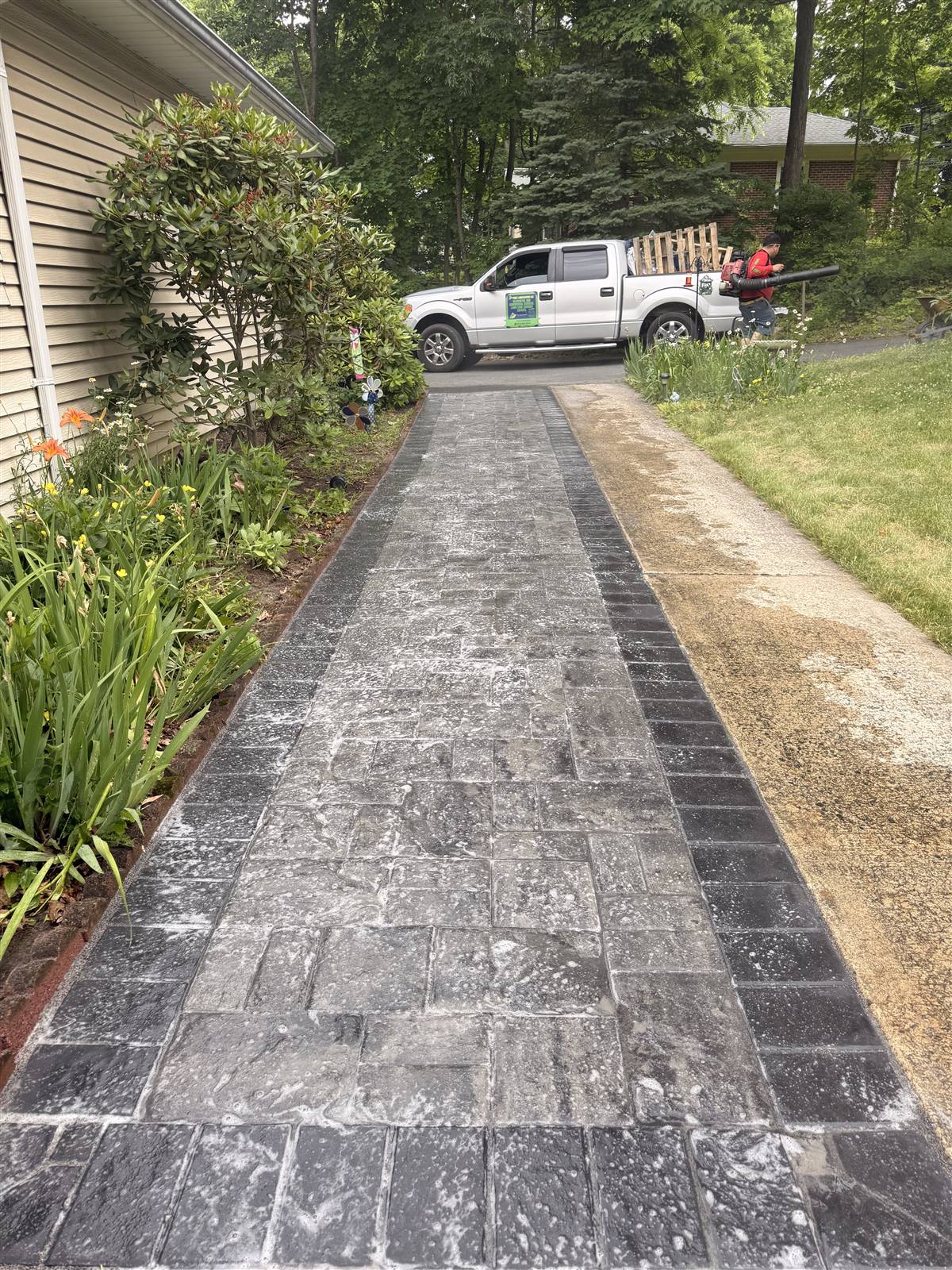 After — finished paver ribbon driveway